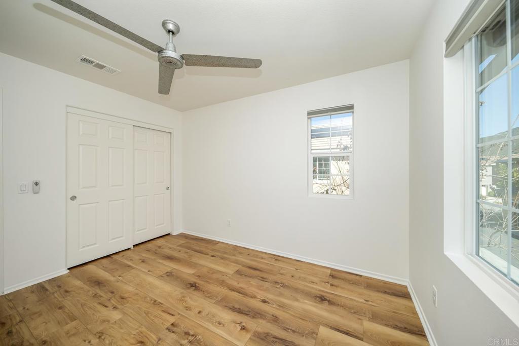 313 Dun Blazer Way Fallbrook, CA 92028 - Photo 31 of 59 a view of empty room with wooden floor and fan