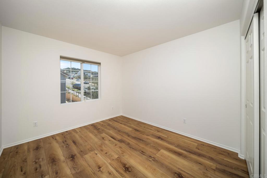 313 Dun Blazer Way Fallbrook, CA 92028 - Photo 33 of 59 a view of empty room with wooden floor and fan
