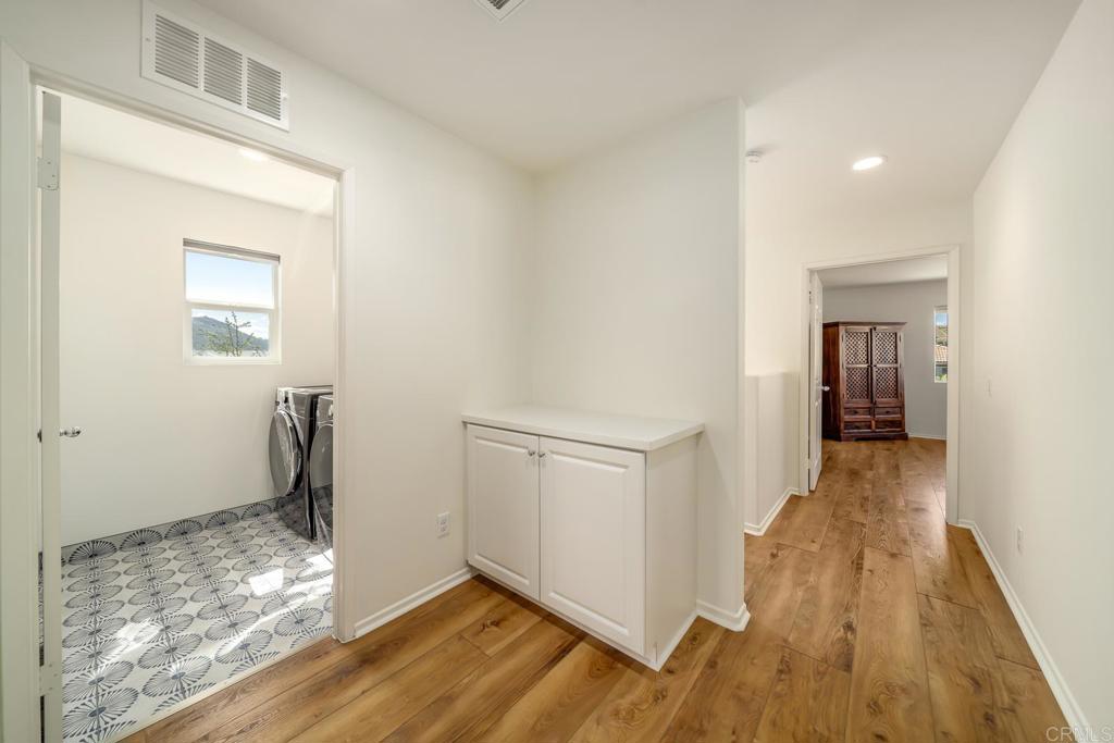 313 Dun Blazer Way Fallbrook, CA 92028 - Photo 35 of 59 a view of a hallway with wooden floor and a bathroom