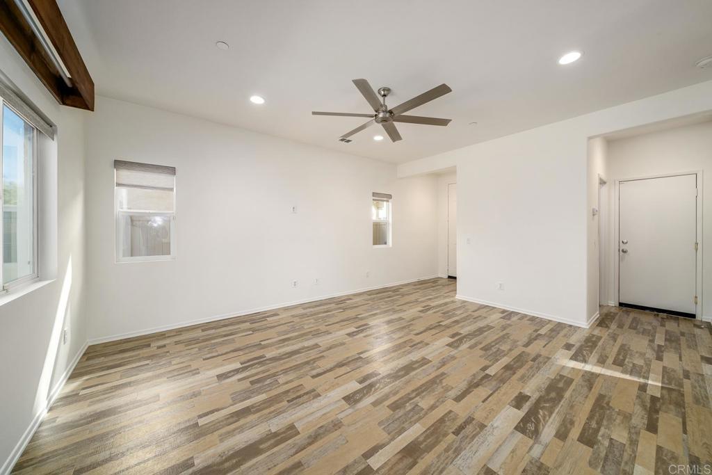 313 Dun Blazer Way Fallbrook, CA 92028 - Photo 7 of 59 a view of empty room with wooden floor and fan