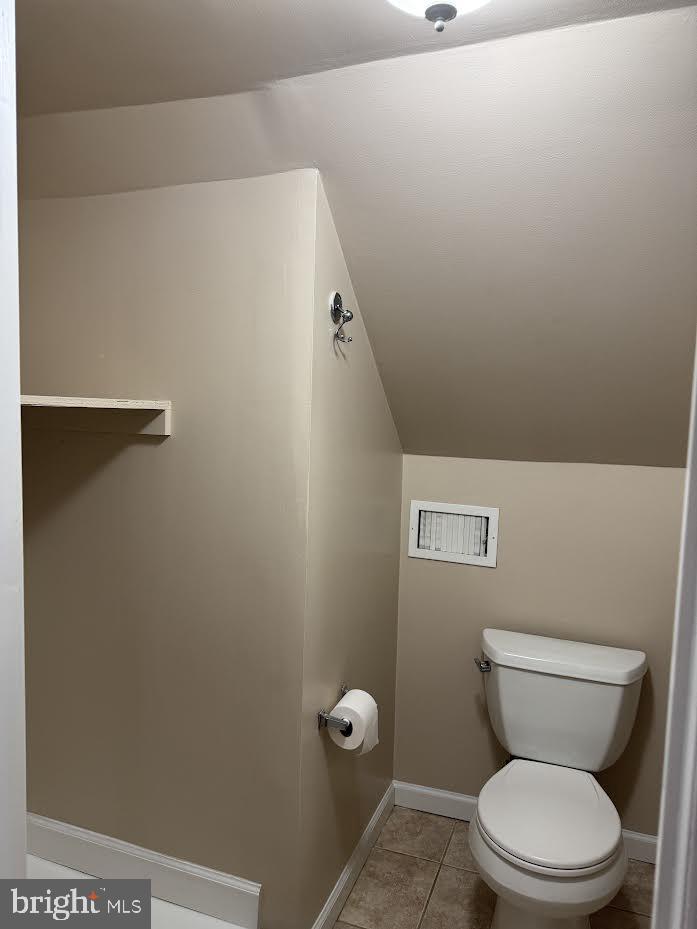 23 Long Avenue, Unit 2 Hillside, NJ 07205 - Photo 13 of 13 a toilet sitting in a bathroom next to a wooden wall