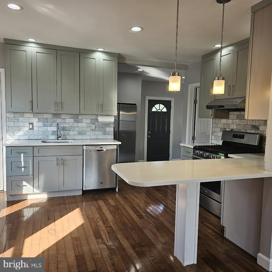 23 Long Avenue, Unit 2 Hillside, NJ 07205 - Photo 2 of 13 a kitchen with kitchen island a sink stove and refrigerator
