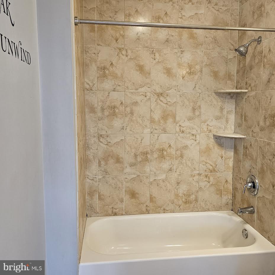 23 Long Avenue, Unit 2 Hillside, NJ 07205 - Photo 10 of 13 a bathroom with a bathtub