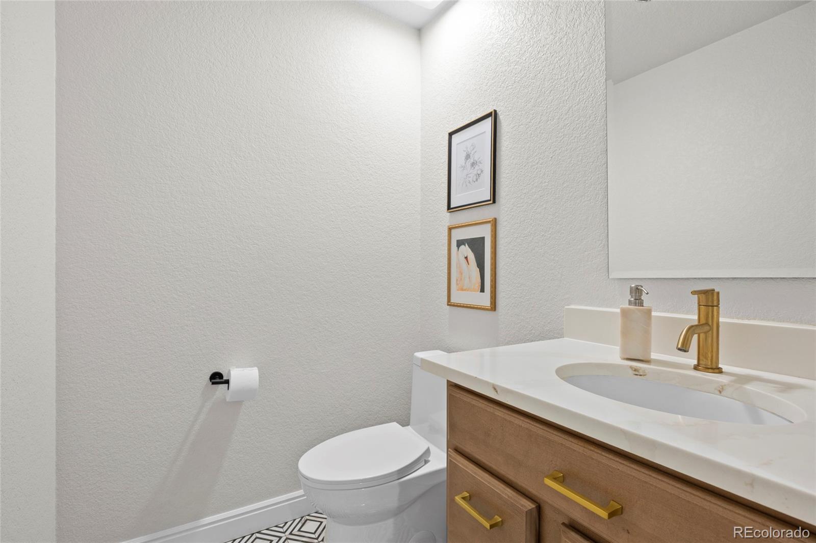 7 Red Maple Place Littleton, CO 80127 - Photo 15 of 50 a bathroom with a sink toilet and vanity