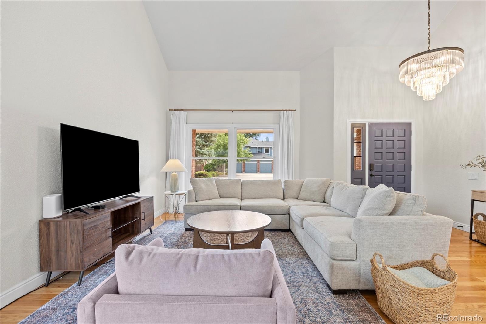 7 Red Maple Place Littleton, CO 80127 - Photo 2 of 50 a living room with furniture a flat screen tv and a window
