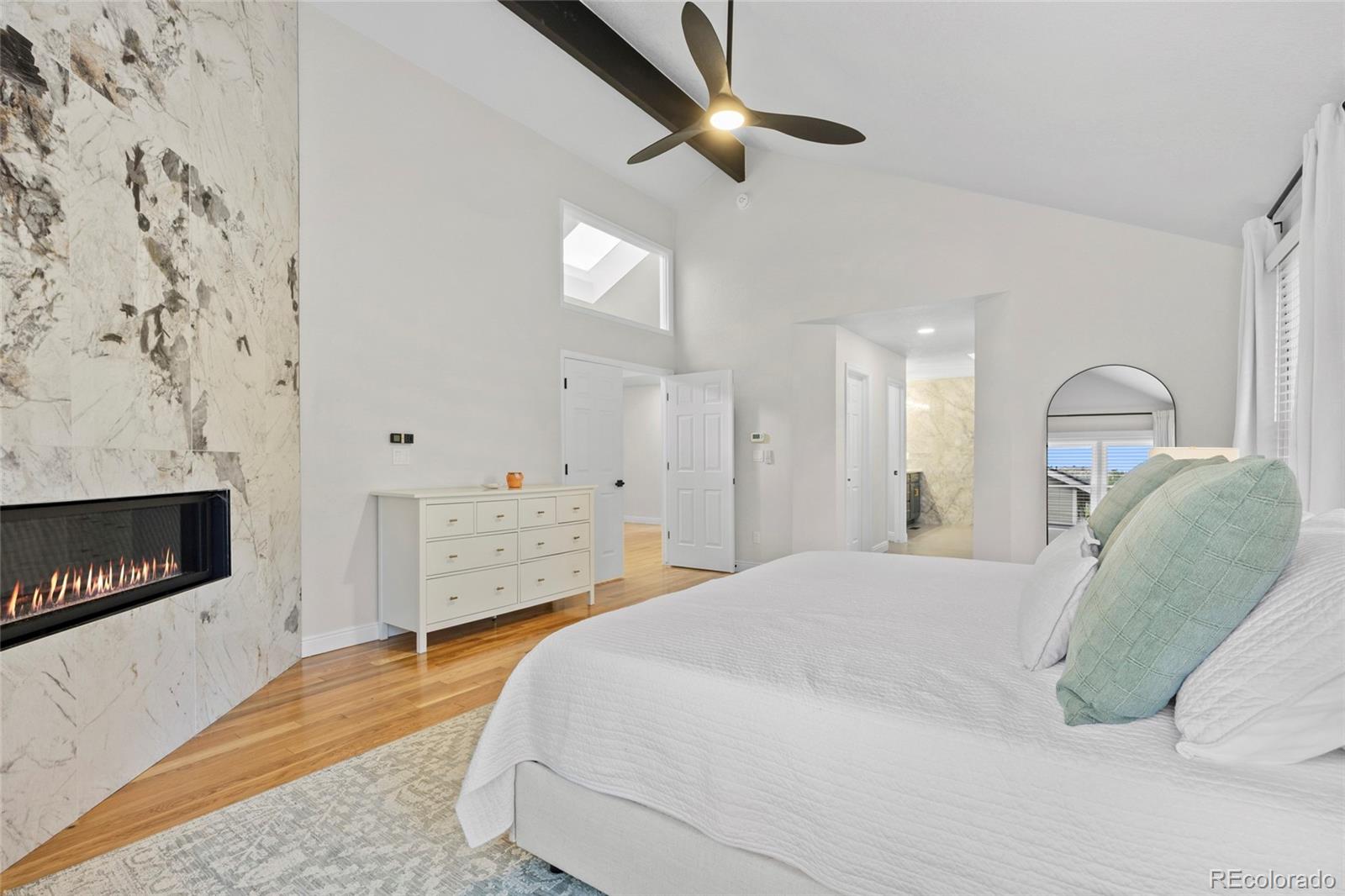 7 Red Maple Place Littleton, CO 80127 - Photo 21 of 50 a bedroom with a bed and a fireplace