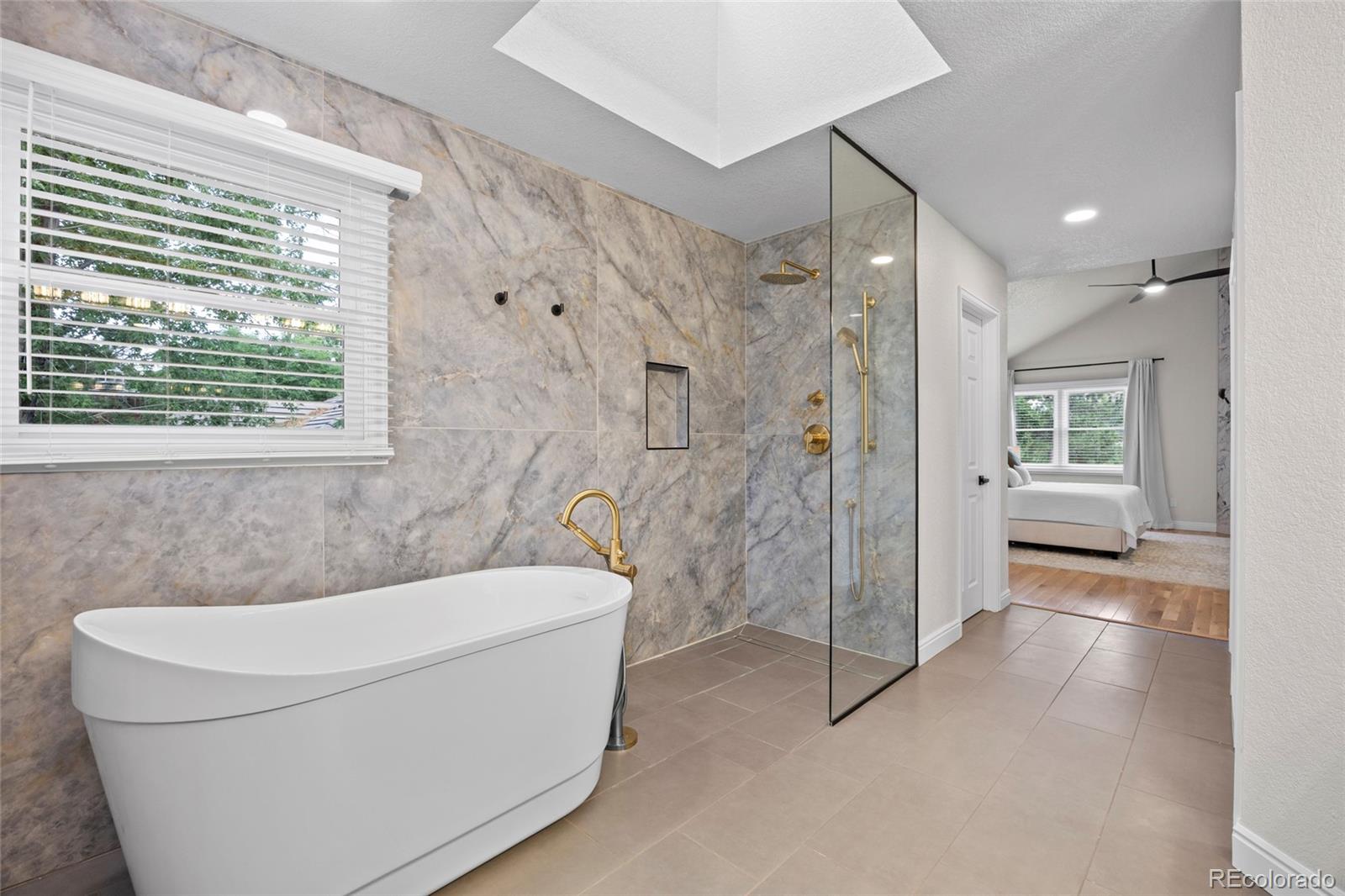 7 Red Maple Place Littleton, CO 80127 - Photo 23 of 50 a bathroom with a bathtub and a shower