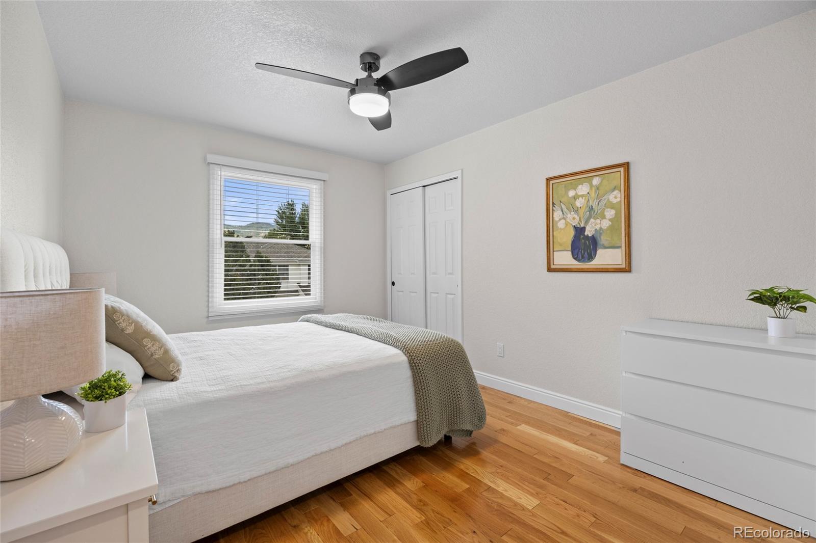 7 Red Maple Place Littleton, CO 80127 - Photo 24 of 50 a bedroom with a large bed and a window