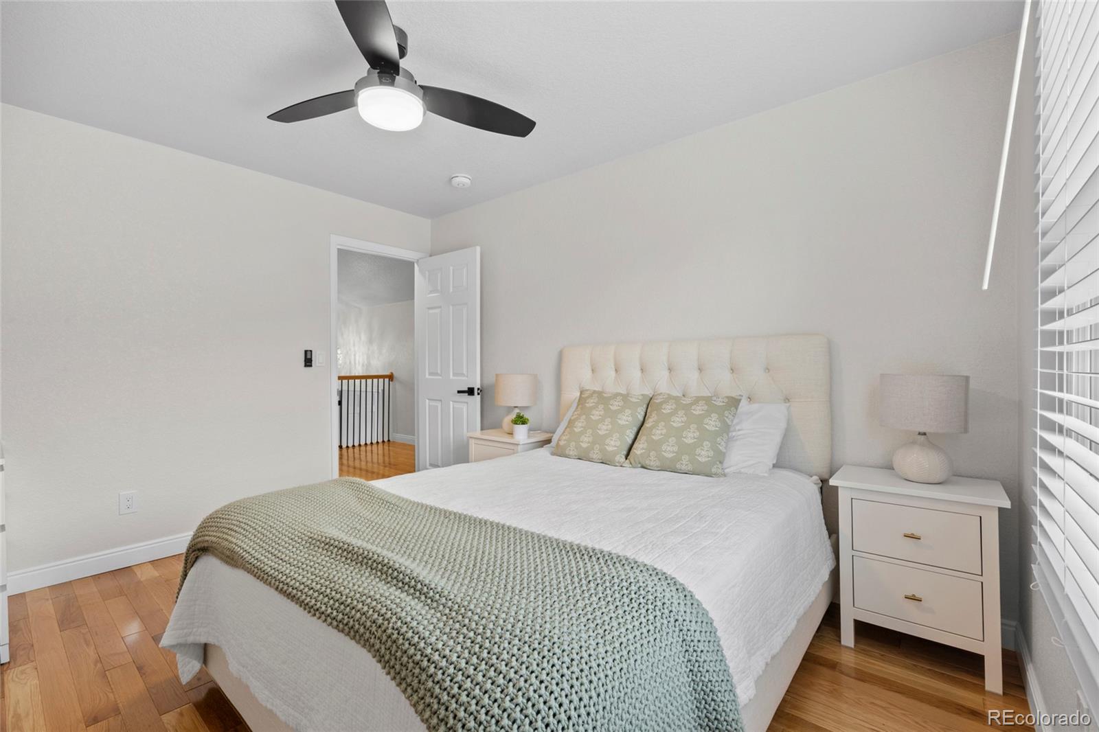 7 Red Maple Place Littleton, CO 80127 - Photo 25 of 50 a bedroom with a bed and a chandelier