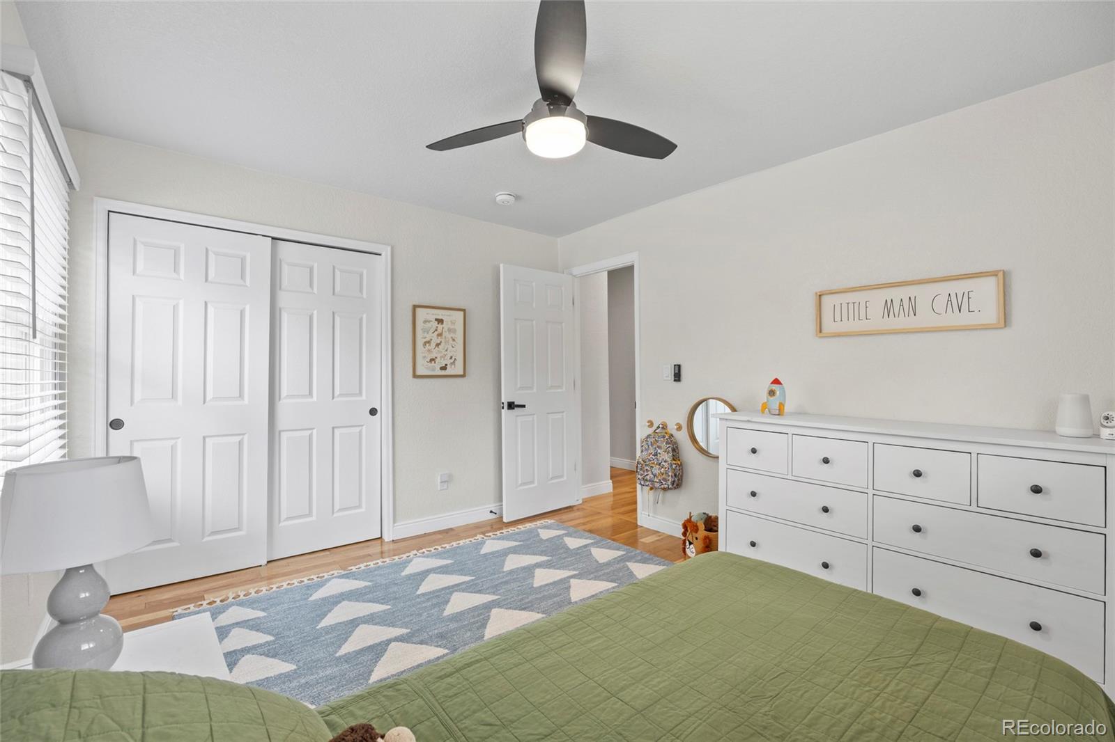 7 Red Maple Place Littleton, CO 80127 - Photo 30 of 50 a bedroom with a bed and a chandelier fan