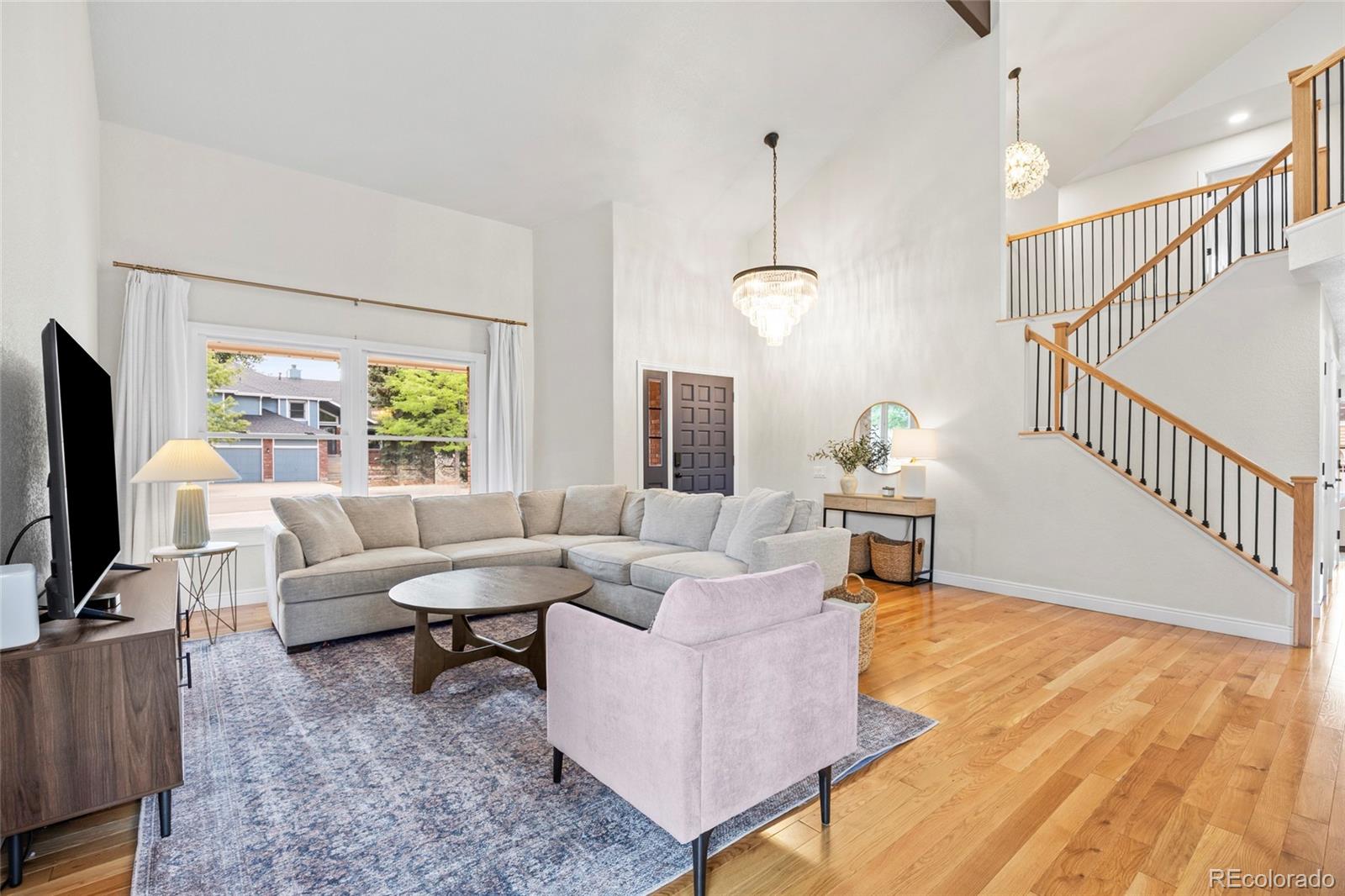 7 Red Maple Place Littleton, CO 80127 - Photo 3 of 50 a living room with furniture and a flat screen tv