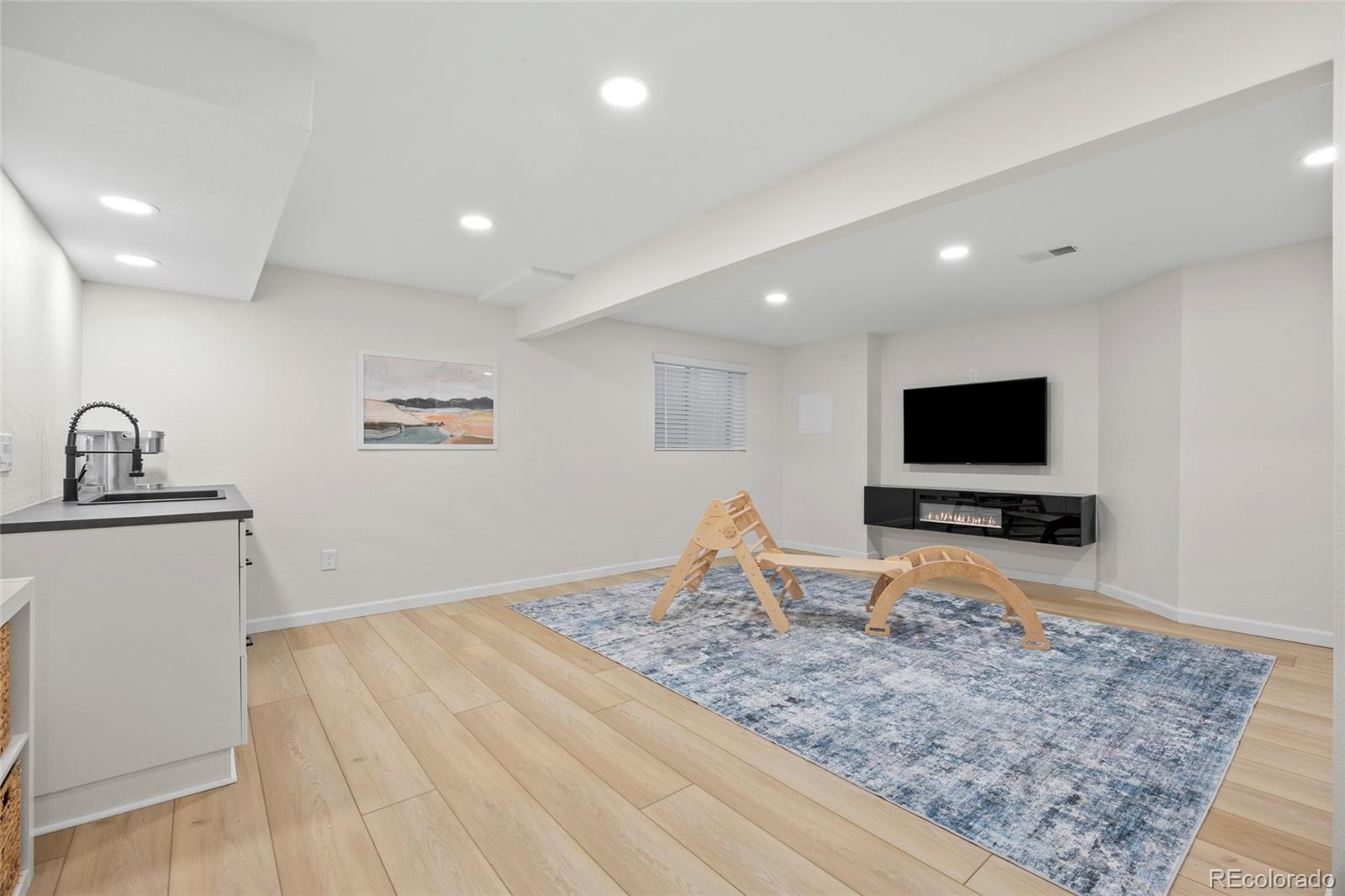 7 Red Maple Place Littleton, CO 80127 - Photo 31 of 50 a living room with furniture and a flat screen tv