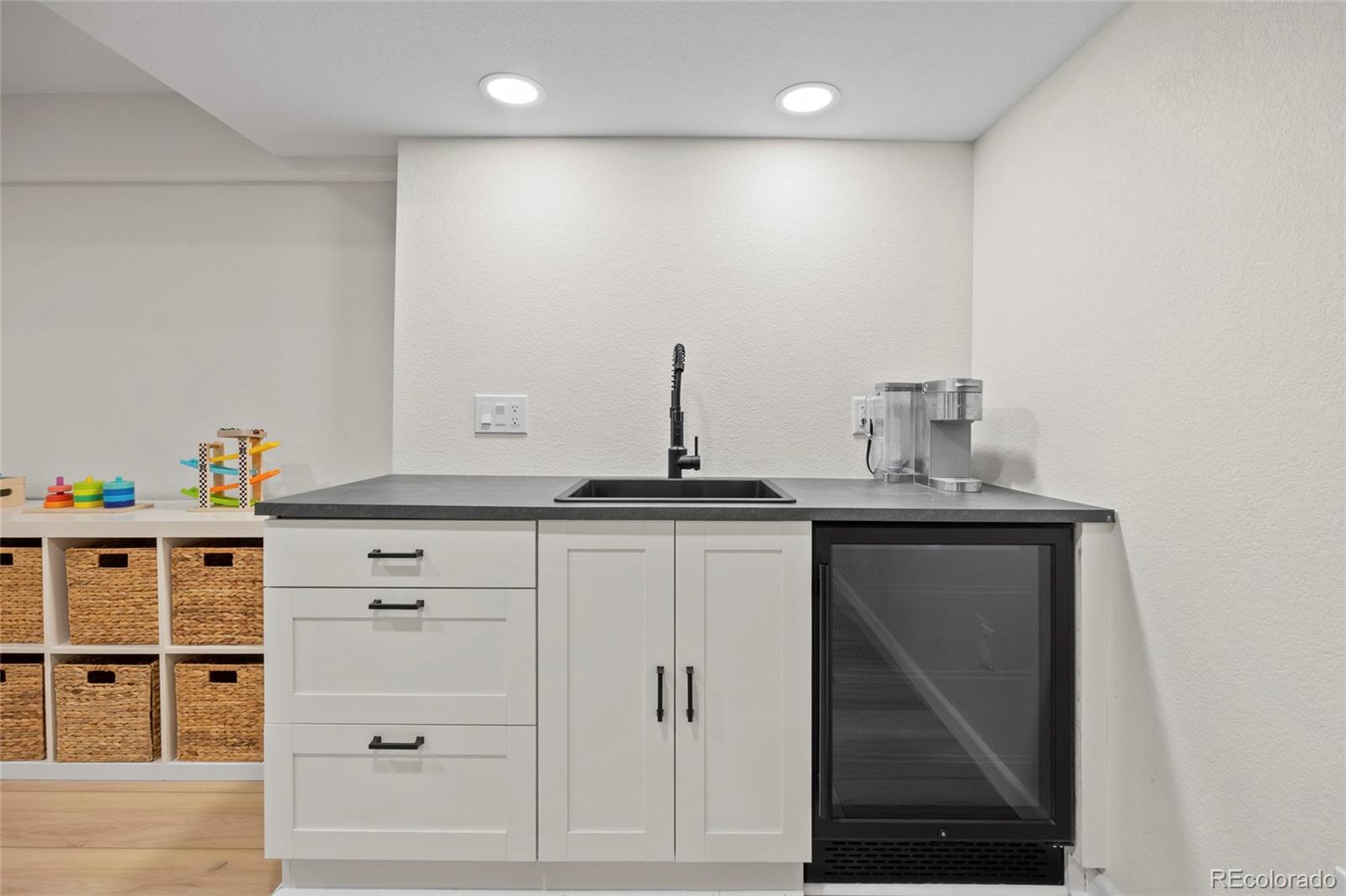 7 Red Maple Place Littleton, CO 80127 - Photo 33 of 50 a view of a kitchen with cabinets and wooden floor