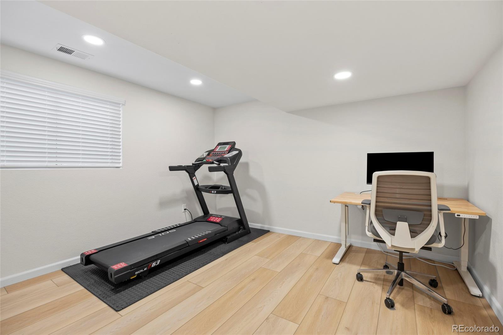 7 Red Maple Place Littleton, CO 80127 - Photo 36 of 50 a room with gym equipment on wooden floor