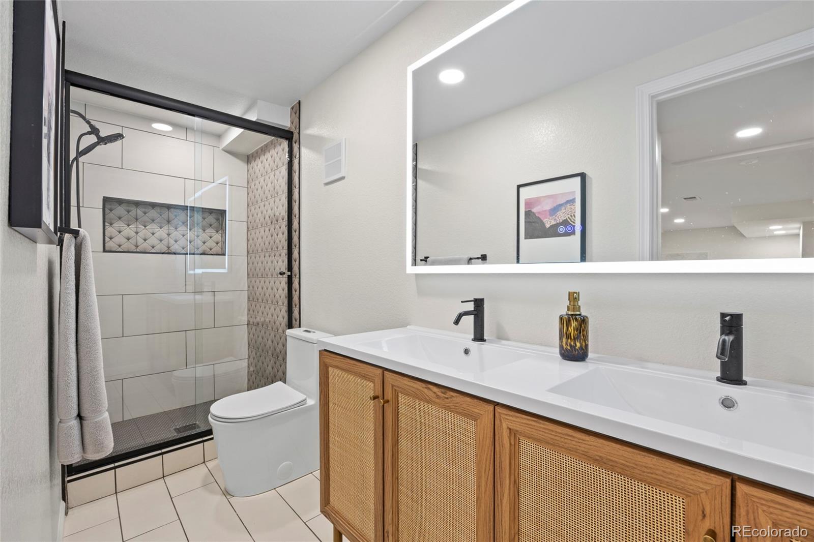 7 Red Maple Place Littleton, CO 80127 - Photo 37 of 50 a bathroom with a sink toilet and shower