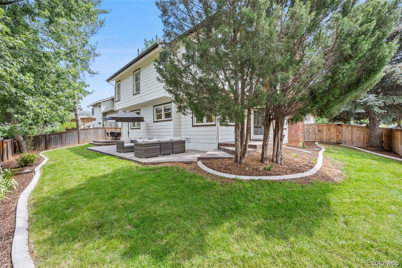 7 Red Maple Place Littleton, CO 80127 - Photo 39 of 50 a front view of a house with garden and trees