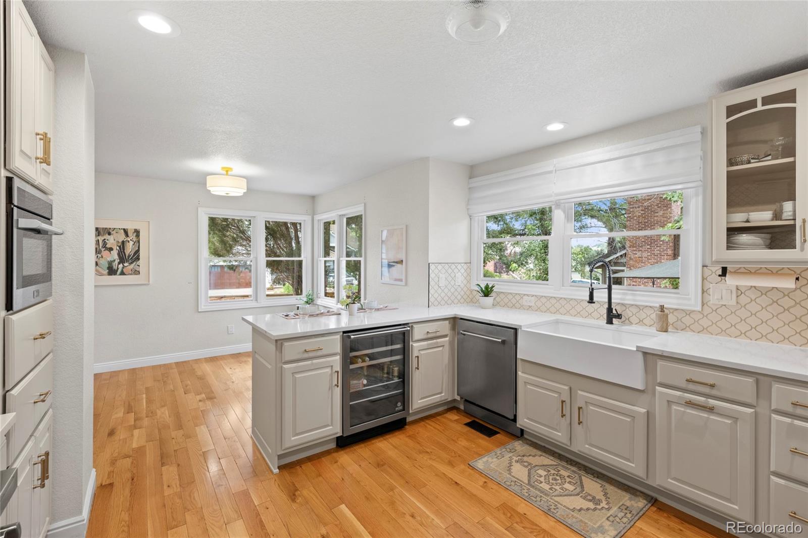 7 Red Maple Place Littleton, CO 80127 - Photo 6 of 50 a large kitchen with stainless steel appliances granite countertop a sink and cabinets
