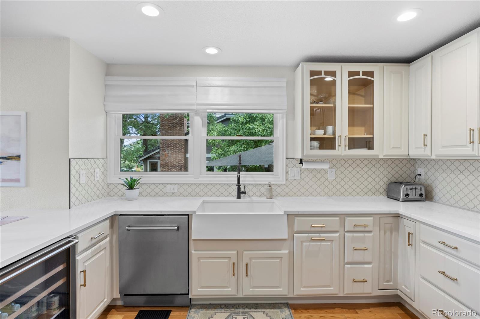 7 Red Maple Place Littleton, CO 80127 - Photo 8 of 50 a kitchen with stainless steel appliances white cabinets and a window