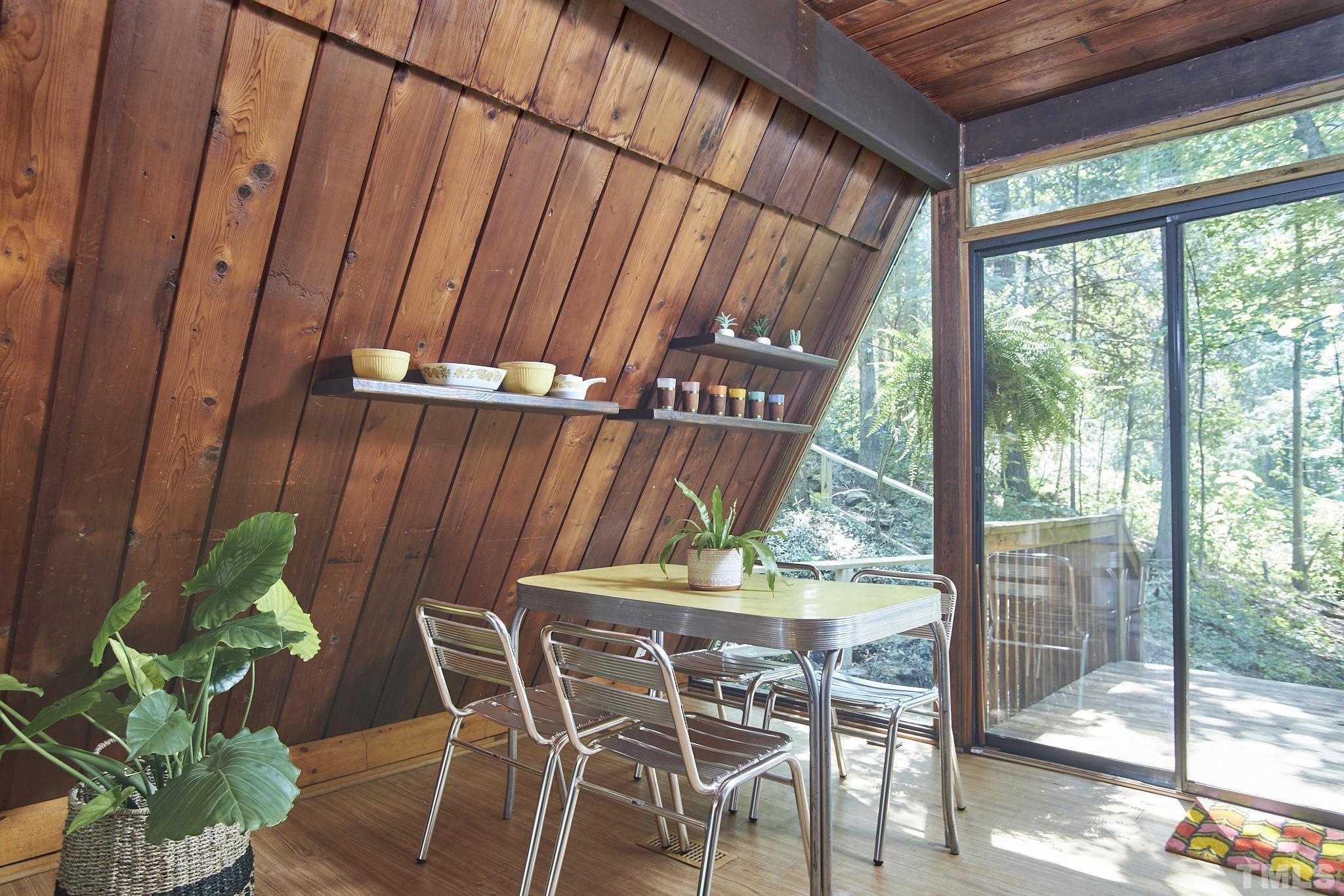 1002 Wave Road Chapel Hill, NC 27517 - Photo 17 of 43 a table and chairs in patio with potted plants