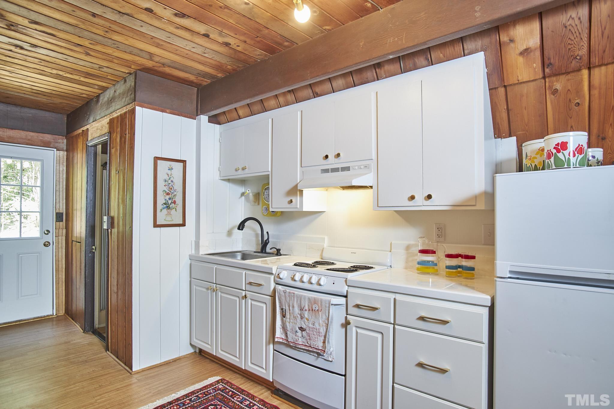 1002 Wave Road Chapel Hill, NC 27517 - Photo 23 of 43 a kitchen with stainless steel appliances granite countertop a refrigerator and a stove