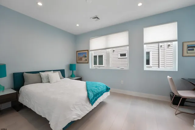 a bed room with a bed and a chair