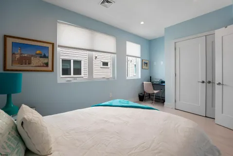 a bedroom with a bed and a chair