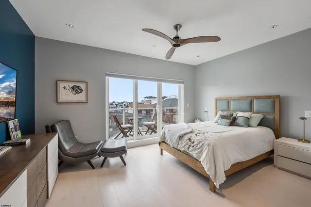 a bedroom with a bed a couch and dresser