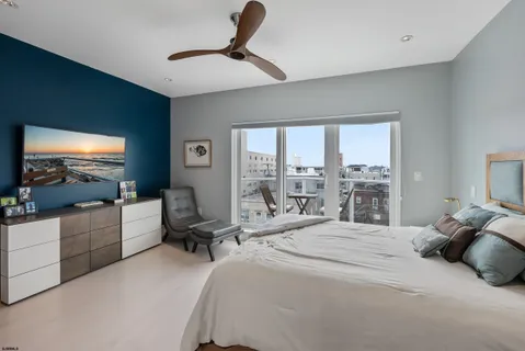 a bedroom with a large bed and a flat screen tv