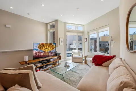a bedroom with furniture and a flat screen tv