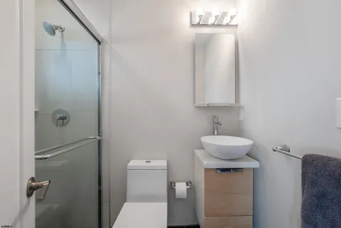 a bathroom with a toilet a sink and mirror