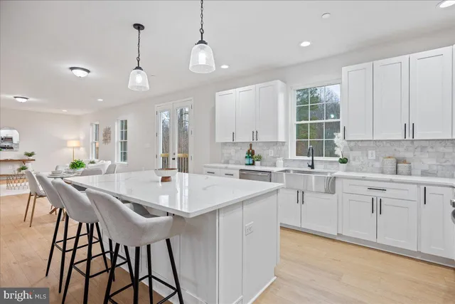 a kitchen with center island table and chairs in it