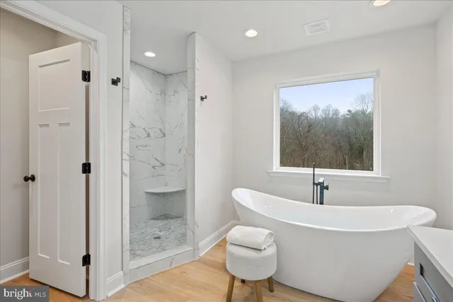 a bathroom with a bathtub and a shower