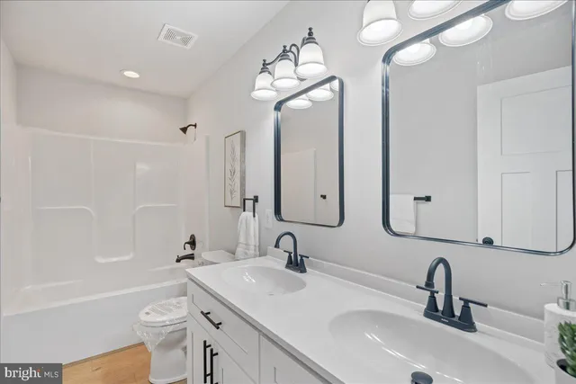 a bathroom with 2 sink and a mirror