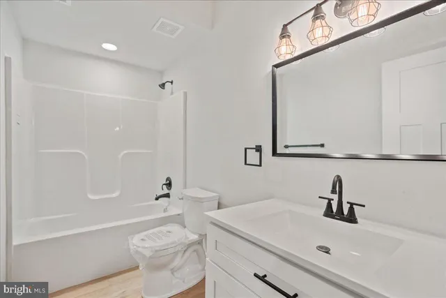 a bathroom with a sink a toilet and a bathtub
