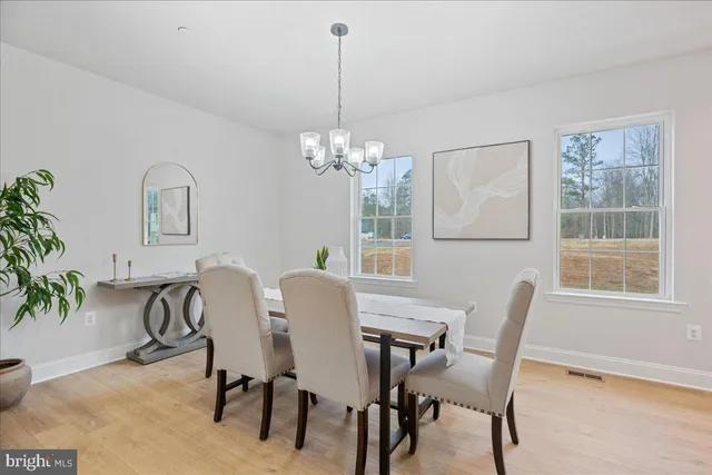 a view of a dining room with furniture and window