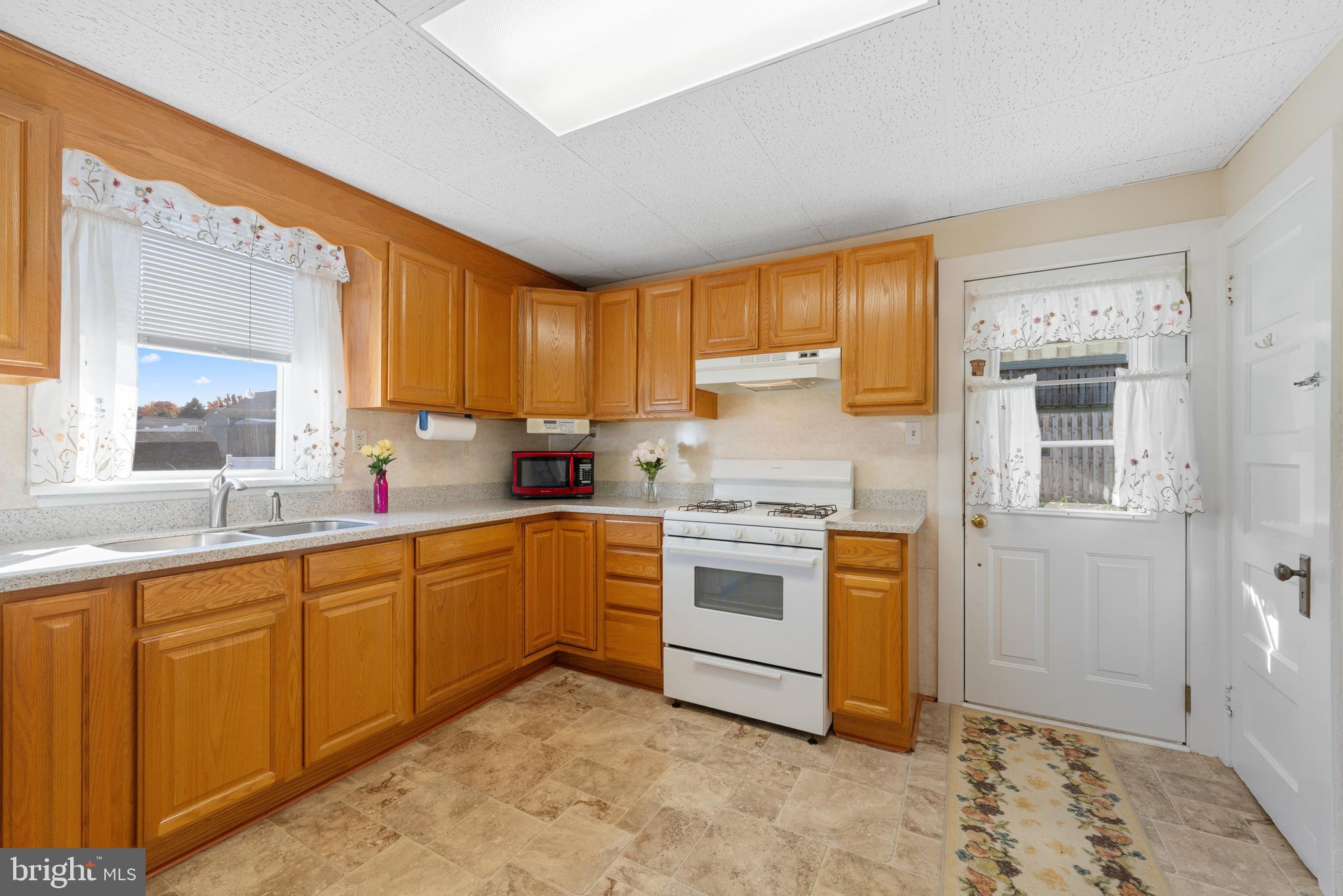 226 South Pine Avenue Maple Shade, NJ 08052 - Photo 14 of 39 a kitchen with granite countertop a sink cabinets stainless steel appliances and a window