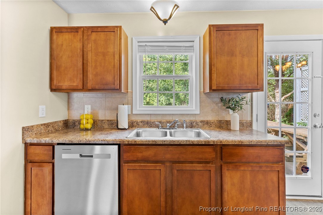 198 Cape Fear Road Raeford, NC 28376 - Photo 11 of 32 a kitchen with granite countertop cabinets sink and window