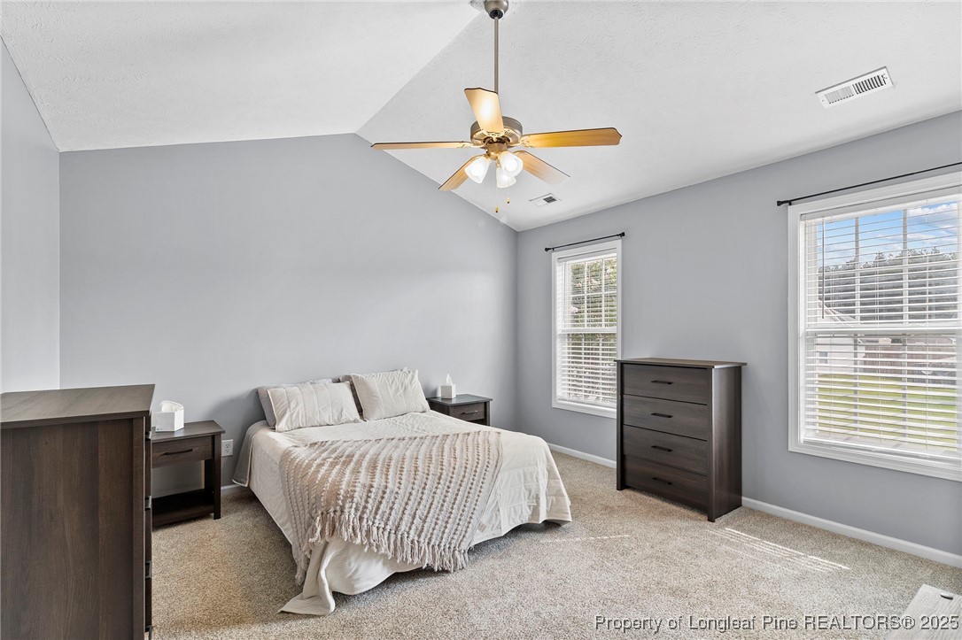198 Cape Fear Road Raeford, NC 28376 - Photo 15 of 32 a bedroom with a bed and window