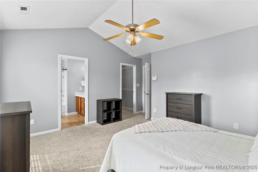 198 Cape Fear Road Raeford, NC 28376 - Photo 16 of 32 a bedroom with a bed and a chandelier
