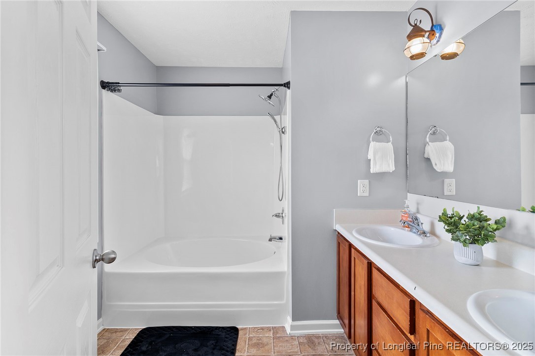 198 Cape Fear Road Raeford, NC 28376 - Photo 18 of 32 a bathroom with a sink a bathtub and a shower