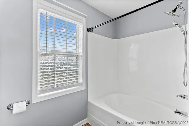 a white bath tub sitting next to a window