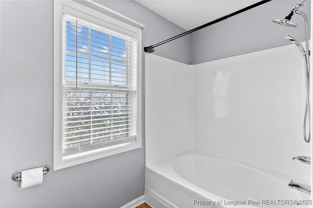198 Cape Fear Road Raeford, NC 28376 - Photo 19 of 32 a white bath tub sitting next to a window