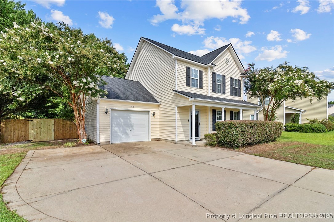 198 Cape Fear Road Raeford, NC 28376 - Photo 2 of 32 a front view of a house with a garden and trees