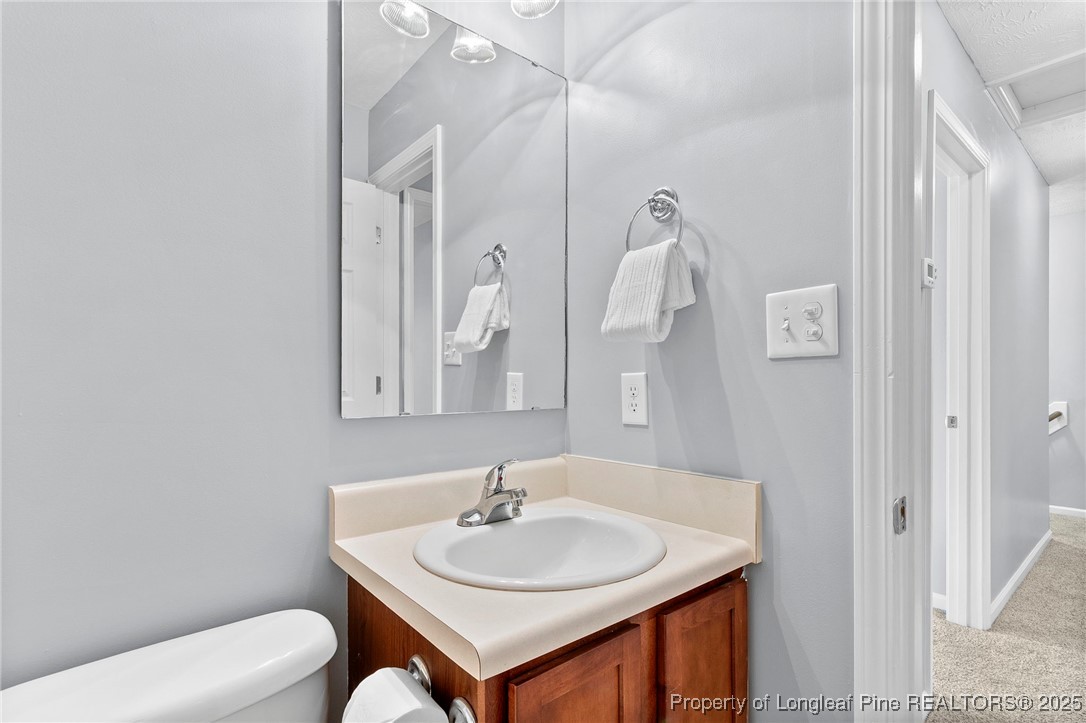 198 Cape Fear Road Raeford, NC 28376 - Photo 24 of 32 a bathroom with a toilet sink and mirror