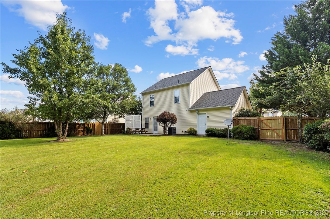 198 Cape Fear Road Raeford, NC 28376 - Photo 30 of 32 a view of a house with a yard and large trees