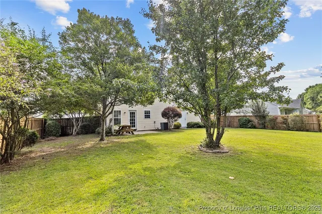 a view of a house with a yard and tree s