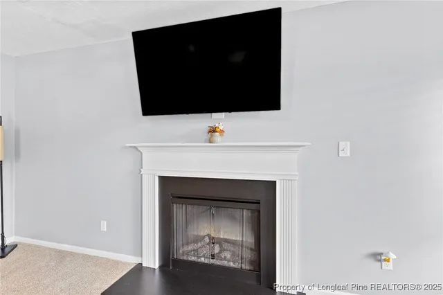 a living room with a fireplace and a flat screen tv