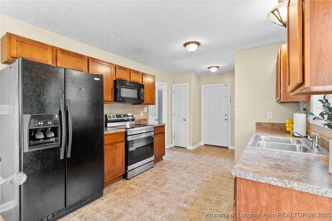 198 Cape Fear Road Raeford, NC 28376 - Photo 10 of 32 a kitchen with stainless steel appliances granite countertop a refrigerator a stove and a sink