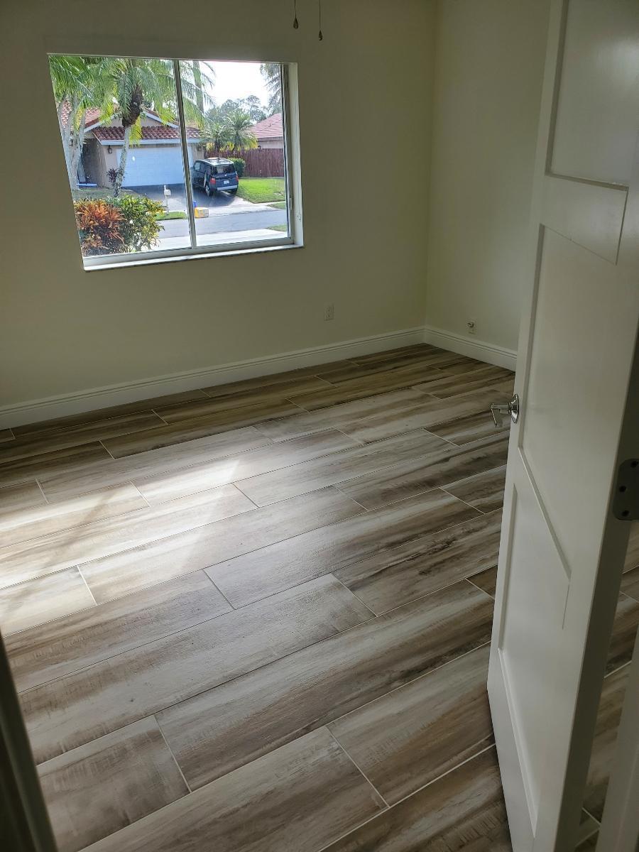 2403 Northwest 30th Road Boca Raton, FL 33431 - Photo 15 of 18 BEDROOM 2 WITH NEW FL0ORS ,BASEBOADS AND