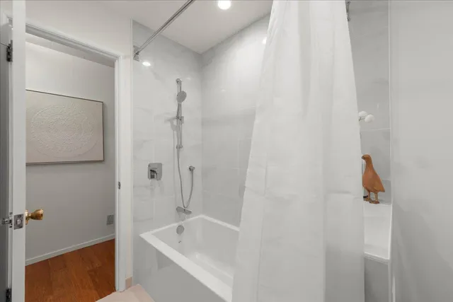 a bathroom with a shower and a tub